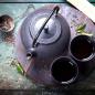 Preview: Alte Teekanne mit 2 Teeschalen und Teesieb rustikaler Hintergrund